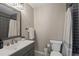 Bathroom with modern vanity, neutral tiling in the shower, and contemporary fixtures at 5885 Wild Azalea Cv, Sugar Hill, GA 30518