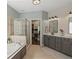 Luxurious bathroom with a soaking tub, separate shower, double vanity and a walk-in closet at 5885 Wild Azalea Cv, Sugar Hill, GA 30518