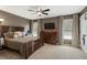 Comfortable bedroom showcasing a large bed, ceiling fan, dresser, and ample natural light at 5885 Wild Azalea Cv, Sugar Hill, GA 30518