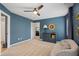 Cozy bedroom featuring a calming blue wall, soft lighting, and comfortable seating at 5885 Wild Azalea Cv, Sugar Hill, GA 30518