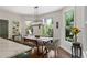 Dining area with backyard views, farmhouse table and chairs with modern chandelier at 5885 Wild Azalea Cv, Sugar Hill, GA 30518