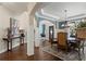 Inviting dining area featuring hardwood floors, elegant decor, and an open view into the foyer and living spaces at 5885 Wild Azalea Cv, Sugar Hill, GA 30518