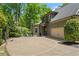 Home exterior features a private driveway with a basketball court and attached garage at 5885 Wild Azalea Cv, Sugar Hill, GA 30518