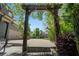 Covered porch leads to a driveway and garage with a basketball hoop and green landscaping at 5885 Wild Azalea Cv, Sugar Hill, GA 30518