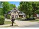 Inviting home with well-maintained lawn, landscaped garden beds, and a spacious driveway leading to the front entrance at 5885 Wild Azalea Cv, Sugar Hill, GA 30518
