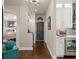 Hallway featuring hardwood floors, gray doors, and a beverage station with a wine fridge at 5885 Wild Azalea Cv, Sugar Hill, GA 30518