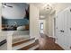 Inviting hallway leading to a comfortable living space with plush seating at 5885 Wild Azalea Cv, Sugar Hill, GA 30518