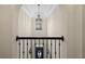 Elegant foyer view from the upper level, showcasing detailed trim and an ornate chandelier at 5885 Wild Azalea Cv, Sugar Hill, GA 30518