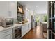 Updated kitchen with white cabinetry, stainless steel appliances, and views to the backyard at 5885 Wild Azalea Cv, Sugar Hill, GA 30518