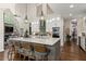 Bright kitchen boasts a large island, sleek countertops, stainless appliances, and modern pendant lighting at 5885 Wild Azalea Cv, Sugar Hill, GA 30518