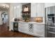 Bright, updated kitchen with stainless steel appliances, white cabinetry and a wine rack at 5885 Wild Azalea Cv, Sugar Hill, GA 30518