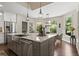 Bright open kitchen with stainless steel appliances, a large island, and backyard views at 5885 Wild Azalea Cv, Sugar Hill, GA 30518