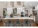 Gourmet kitchen features a marble island with seating, stainless steel appliances, and open shelving at 5885 Wild Azalea Cv, Sugar Hill, GA 30518