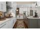 Kitchen featuring stainless steel appliances, white cabinetry, and a spacious island with sink at 5885 Wild Azalea Cv, Sugar Hill, GA 30518
