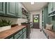 Spacious laundry room featuring custom cabinets, countertops, and modern appliances at 5885 Wild Azalea Cv, Sugar Hill, GA 30518