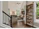 Open concept living room with a fireplace and views of the back deck at 5885 Wild Azalea Cv, Sugar Hill, GA 30518