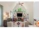 Vaulted ceiling living room features a stone fireplace, lots of natural light, and decorative lighting at 5885 Wild Azalea Cv, Sugar Hill, GA 30518