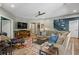Comfortable living room featuring a large sofa, TV, and stairs to the upper level at 5885 Wild Azalea Cv, Sugar Hill, GA 30518