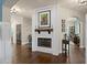 Cozy living room with fireplace, hardwood floors, and open doorway to the office, perfect for relaxation at 5885 Wild Azalea Cv, Sugar Hill, GA 30518
