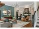 Comfortable living room with fireplace, hardwood floors, stylish seating, and a decorative area rug at 5885 Wild Azalea Cv, Sugar Hill, GA 30518