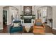 Bright living room features a brick fireplace, mantle, with two stylish chairs, and hardwood floors at 5885 Wild Azalea Cv, Sugar Hill, GA 30518
