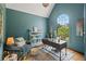Stylish home office featuring a large arched window, ample natural light, and a tranquil workspace at 5885 Wild Azalea Cv, Sugar Hill, GA 30518