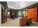 Spacious office featuring an executive desk with an abundance of natural light and sitting area at 5885 Wild Azalea Cv, Sugar Hill, GA 30518