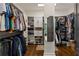 Well-organized walk-in closet with custom shelving, hanging rods, and a full-length mirror at 5885 Wild Azalea Cv, Sugar Hill, GA 30518