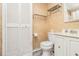 Cozy bathroom featuring a toilet, sink, shelving and a closet with bi-fold doors at 11 Forrest Pl, Atlanta, GA 30328