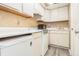 Functional kitchen featuring white appliances and ample cabinet space at 11 Forrest Pl, Atlanta, GA 30328