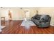 Open-concept living room featuring hardwood floors and a plush gray couch at 11 Forrest Pl, Atlanta, GA 30328