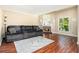 Cozy living room featuring a fireplace and plush gray sofa with blanket and pillows at 11 Forrest Pl, Atlanta, GA 30328