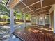 Covered back porch featuring a spacious seating area with views of the backyard and patio at 1417 Wind Chime Ct, Lawrenceville, GA 30045