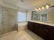 Bathroom featuring double vanities, bathtub, glass-enclosed shower with tile surround at 1417 Wind Chime Ct, Lawrenceville, GA 30045