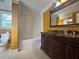 Bathroom with marble countertops, a dark wood vanity, and tub-shower combo at 1417 Wind Chime Ct, Lawrenceville, GA 30045