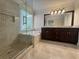 Beautiful bathroom with a double sink vanity, a glass-enclosed shower, and a soaking tub at 1417 Wind Chime Ct, Lawrenceville, GA 30045