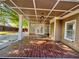 Spacious covered patio featuring a stylish wood-look tile floor and recessed lighting for outdoor enjoyment at 1417 Wind Chime Ct, Lawrenceville, GA 30045