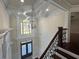 Grand foyer with a beautiful chandelier, decorative molding, and elegant staircase with iron spindles at 1417 Wind Chime Ct, Lawrenceville, GA 30045