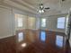Bright living room with hardwood floors, a tray ceiling, and natural light streaming through the windows at 1417 Wind Chime Ct, Lawrenceville, GA 30045