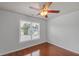 Bright bedroom with ceiling fan, hardwood floors, and a window with blinds; simple and cozy space at 1425 Bridle Path Dr, Lawrenceville, GA 30045