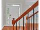 Bright entryway with hardwood floors, white trim, and front door with sidelights and transom window at 1425 Bridle Path Dr, Lawrenceville, GA 30045