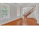 Foyer featuring hardwood floors, a staircase, and natural light from large windows at 1425 Bridle Path Dr, Lawrenceville, GA 30045
