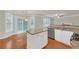 Open kitchen with granite countertops, stainless steel appliances, white cabinets, and eat-in island at 1425 Bridle Path Dr, Lawrenceville, GA 30045
