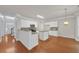 Open-concept kitchen featuring white cabinets, granite countertops, and an island at 1425 Bridle Path Dr, Lawrenceville, GA 30045