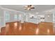Open-concept living room featuring hardwood floors and views into the kitchen area at 1425 Bridle Path Dr, Lawrenceville, GA 30045
