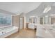 Bright main bathroom with a tub, a separate shower, and a dual-sink vanity, providing a spa-like experience at 1425 Bridle Path Dr, Lawrenceville, GA 30045