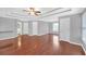 Spacious main bedroom features tray ceilings, hardwood floors, and windows, creating a luxurious retreat at 1425 Bridle Path Dr, Lawrenceville, GA 30045