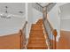 Elegant wooden staircase with iron railing, adding a touch of sophistication to the home's entry at 1425 Bridle Path Dr, Lawrenceville, GA 30045