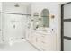 Elegant bathroom features a double sink vanity, arch mirrors, gold accents and glass enclosed shower at 156 Martha Ne Ave, Atlanta, GA 30317