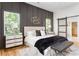 Bedroom with wainscoting, hardwood floors, and a sliding barn door to the closet at 156 Martha Ne Ave, Atlanta, GA 30317